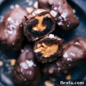 Close-up of a chocolate-covered date, sliced open to reveal the rich peanut butter and chopped nut filling.
