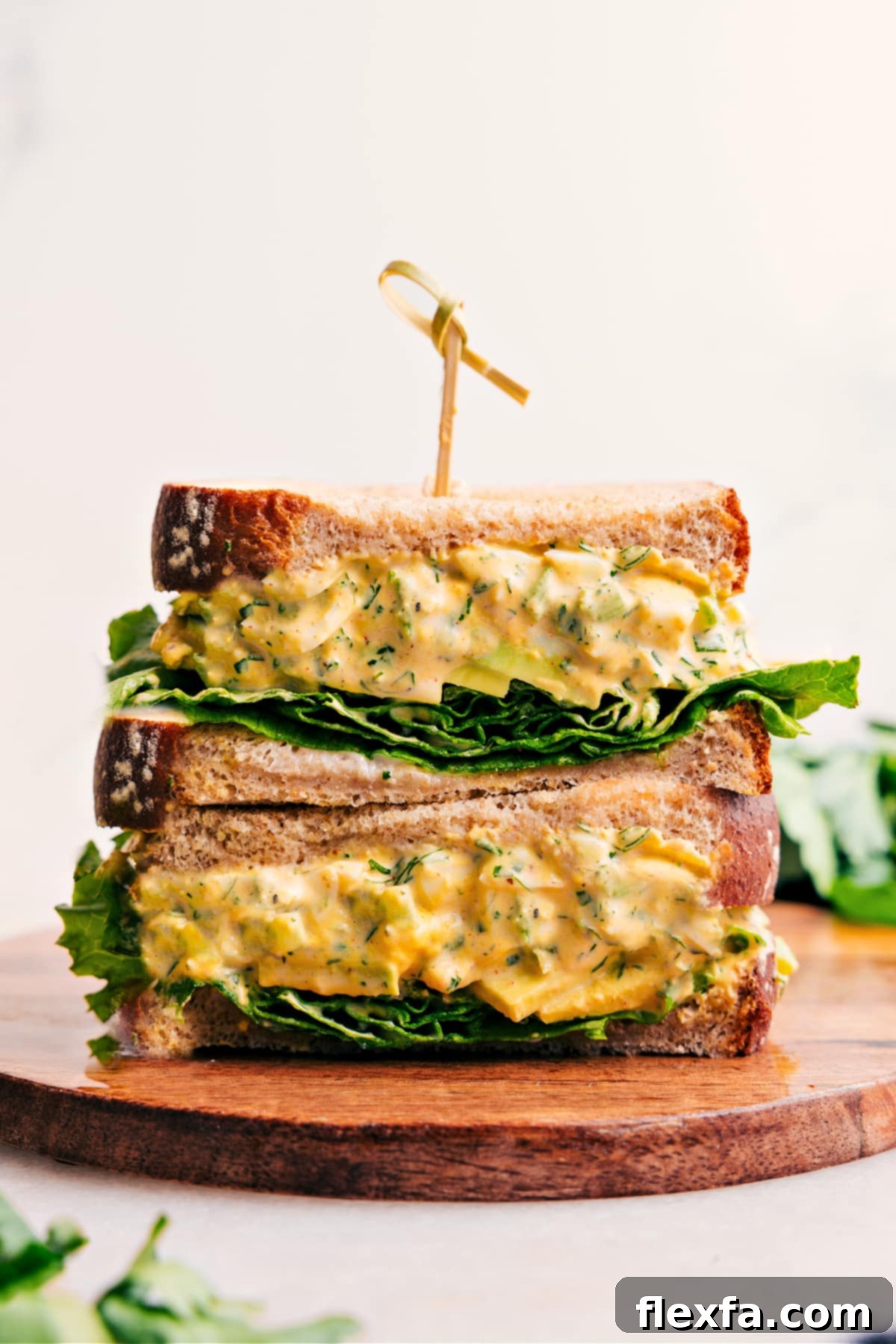 Perfectly stacked egg salad sandwiches, ready to be enjoyed as a delightful meal or snack.