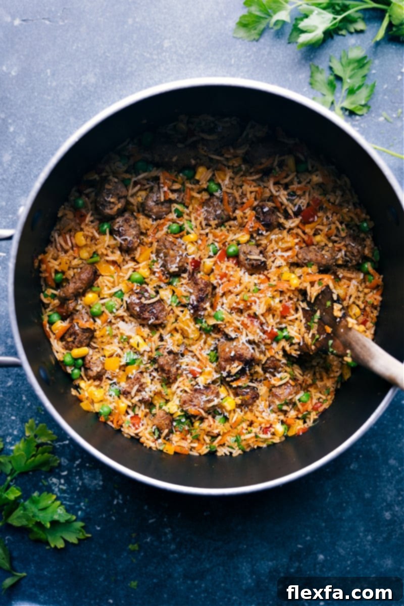Overhead image of a hearty serving of one-pot meatballs and rice, garnished with fresh herbs