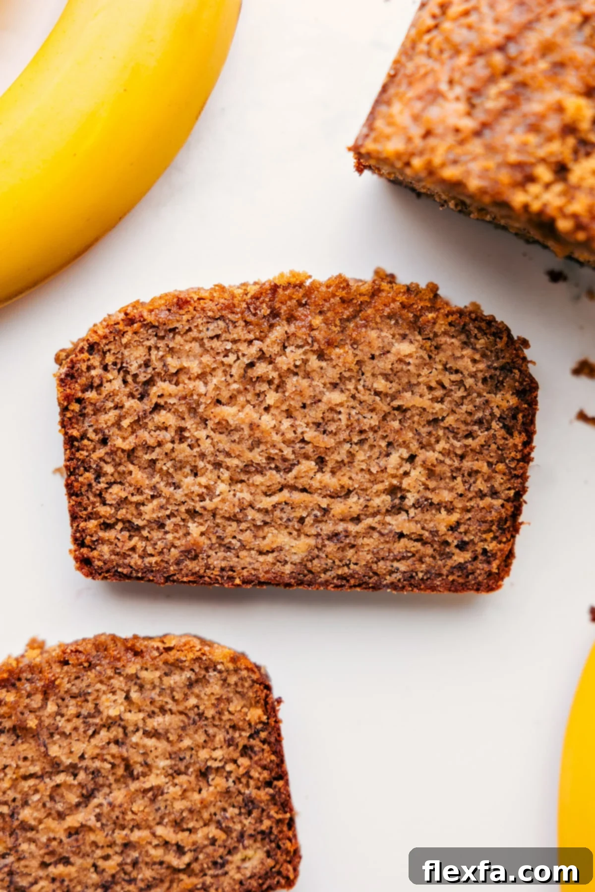 Sliced Healthy Banana Bread A perfectly sliced piece of Greek yogurt banana bread, revealing its moist texture and ready to be enjoyed with a cup of coffee.