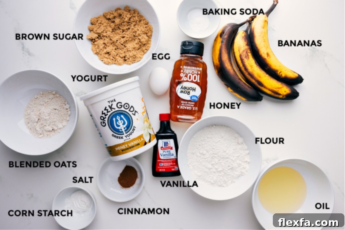 Ingredients In Greek Yogurt Banana Bread All the essential ingredients for Greek Yogurt Banana Bread are neatly arranged, including very ripe bananas, Greek yogurt, eggs, coconut oil, brown sugar, honey, vanilla, cinnamon, baking soda, salt, all-purpose flour, and homemade oat flour.