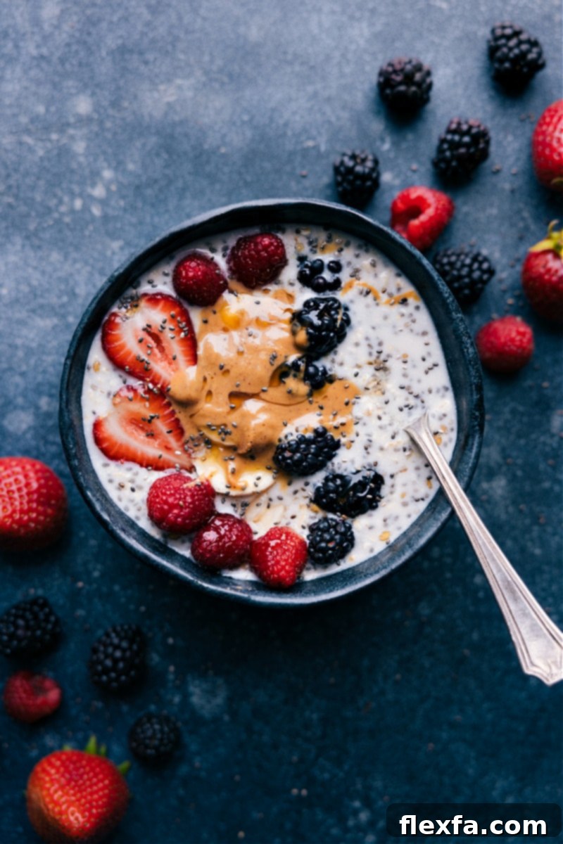 Delicious Overnight Oats with Chia Seeds, generously topped with creamy nut butter and vibrant fresh berries, ready to eat for a healthy breakfast.