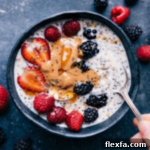 Overnight Oats with Chia Seeds in a glass jar, topped with fresh berries and a drizzle of nut butter, ready for breakfast.