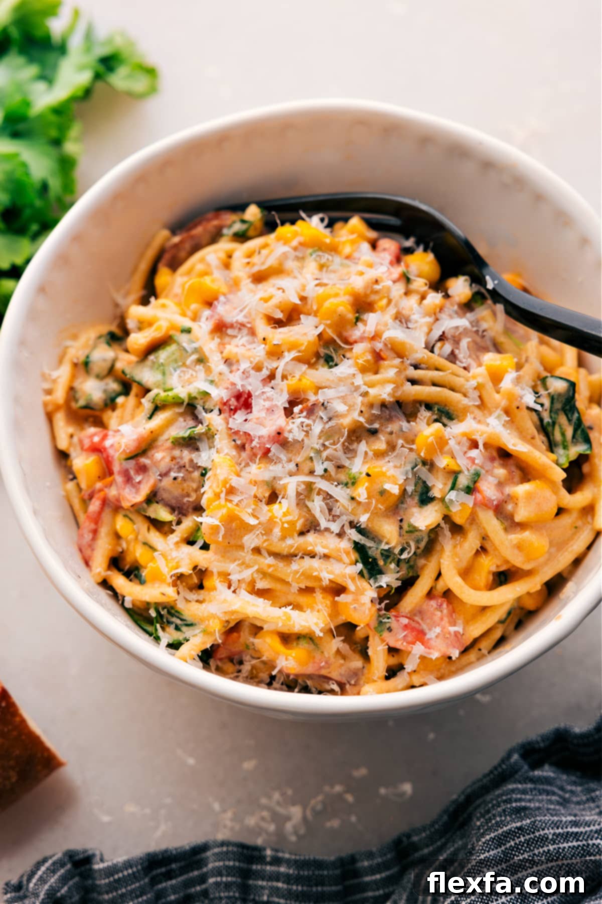Vibrant Corn And Sausage Pasta Recipe Creamy Corn and Sausage Pasta topped with fresh parmesan and herbs, served in a rustic bowl.