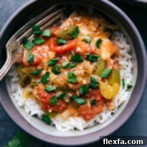Cajun crockpot chicken complete, with vegetables and rich flavors, in a bowl ready for consumption.