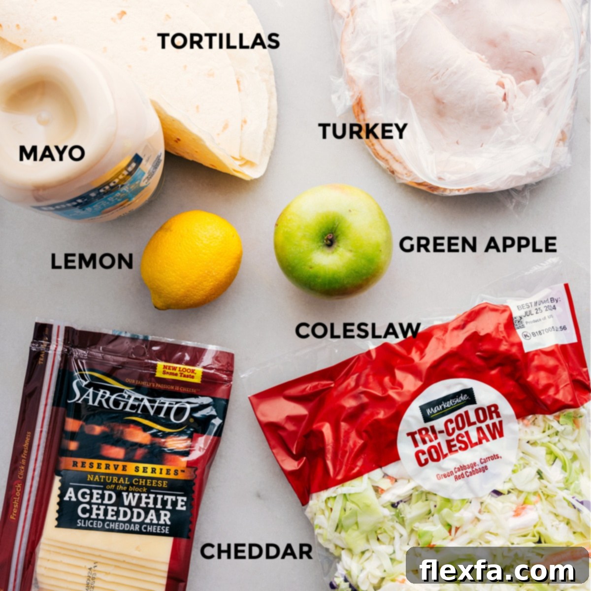 All the fresh ingredients for healthy turkey wraps laid out on a counter, ready for assembly.