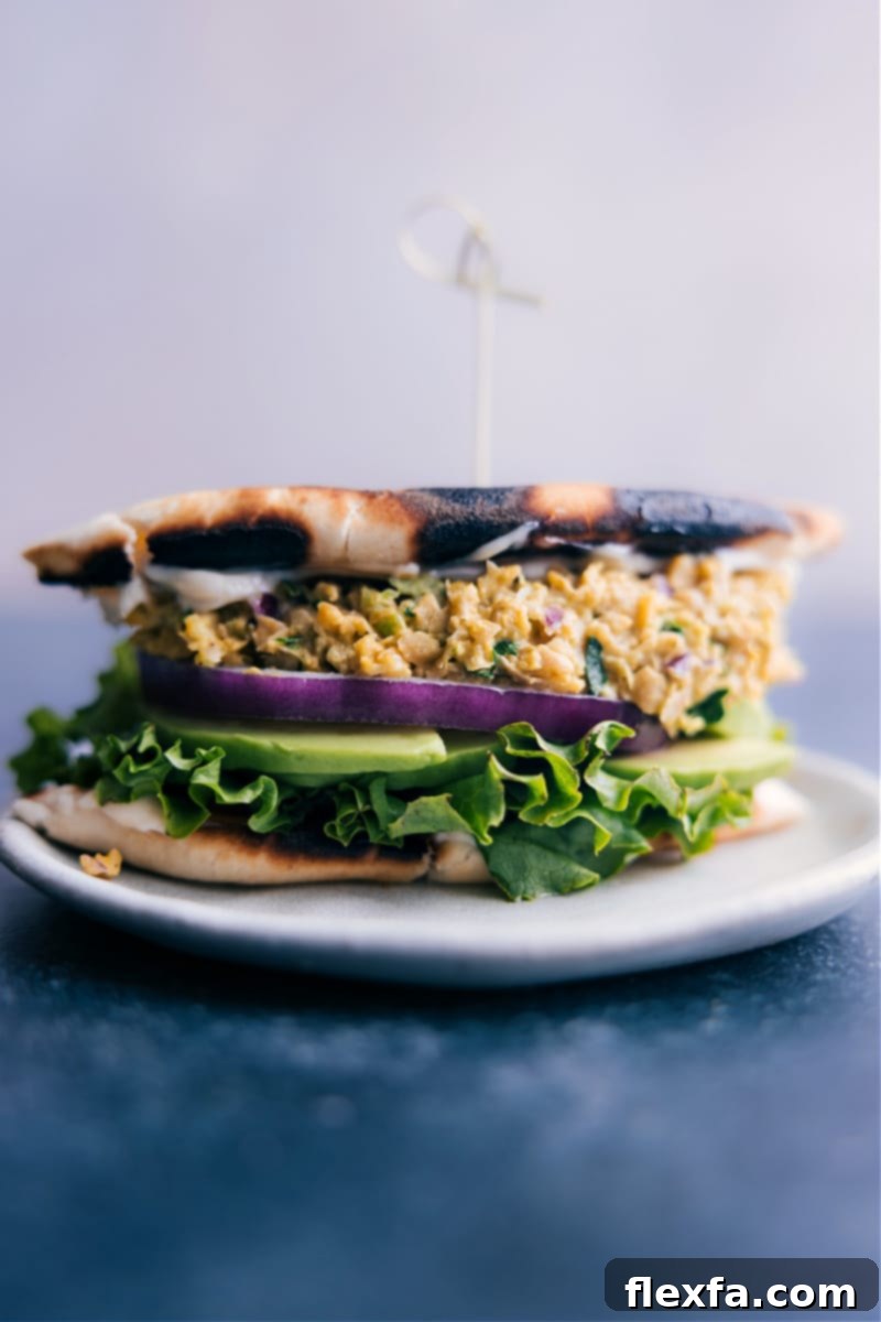 Overhead image of a vibrant Curried Chickpea Salad served with fresh pita bread and lettuce.