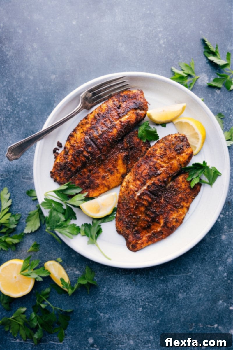 Perfectly cooked Air Fryer Tilapia fillets seasoned with two different spice rubs, ready to serve.