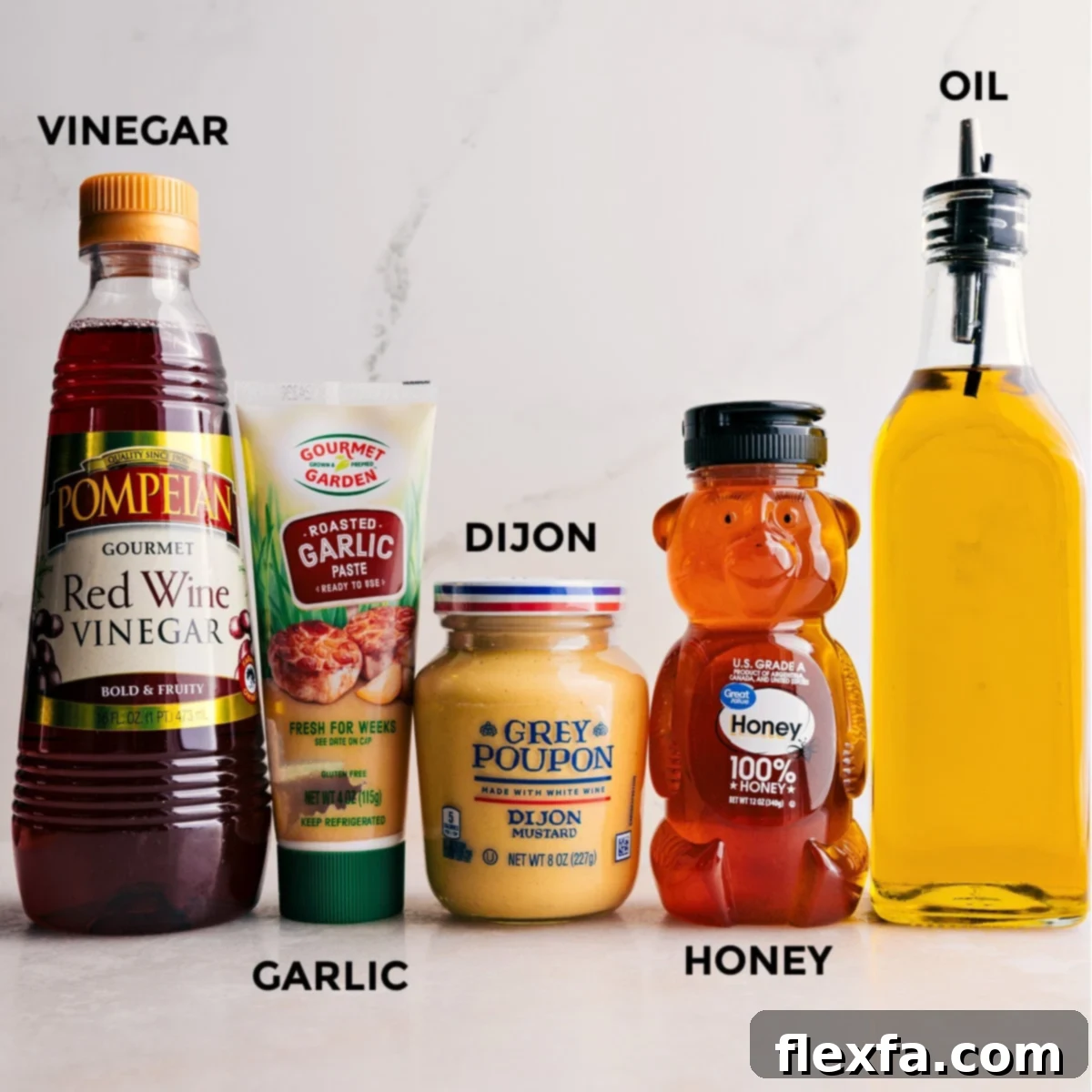 All the essential ingredients for the quick and easy homemade dressing used in this everyday salad recipe are neatly laid out, including golden honey, rich olive oil, creamy Dijon mustard, fragrant minced garlic, and tangy red wine vinegar.