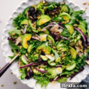 A freshly made Everyday Salad in a clear bowl with a corner view, highlighting the crisp greens and colorful vegetables, ready to be served.