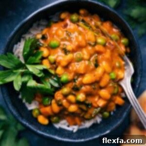 A finished bowl of the Quick Vegan Curry served with rice and fresh herbs.