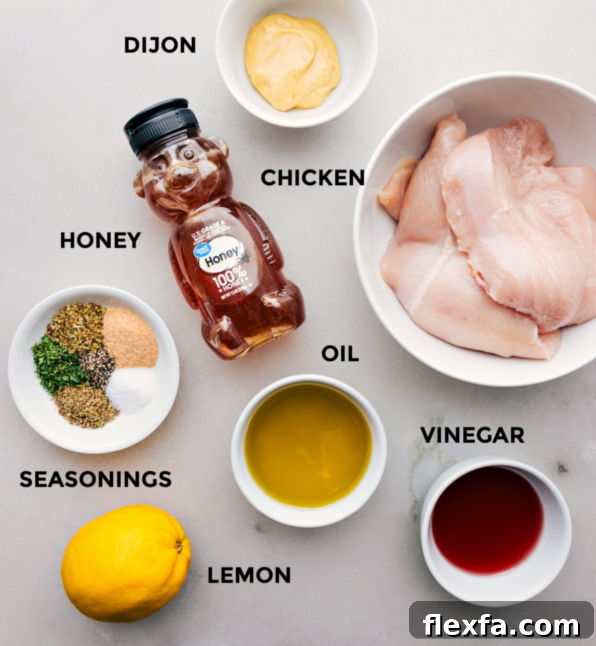 All the ingredients for the Italian chicken marinade prepped out for easy assembly, including fresh lemons, olive oil, and various dried herbs.