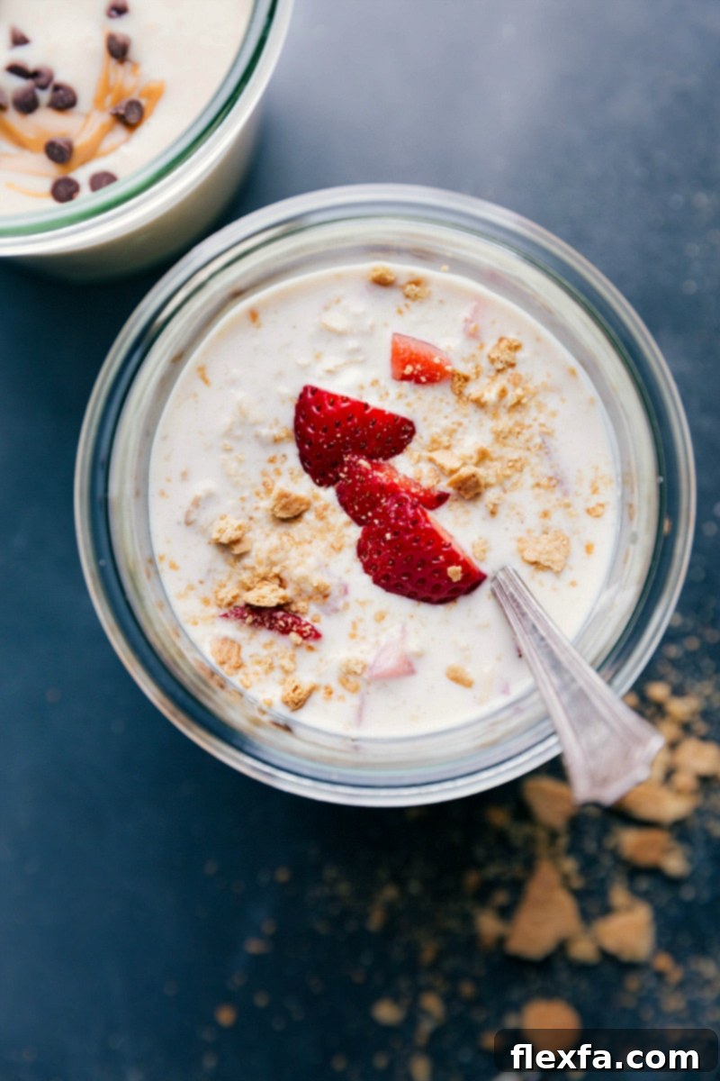 Finished strawberry cheesecake overnight oats, beautifully topped with fresh, vibrant strawberries, making for a perfect and healthy breakfast.
