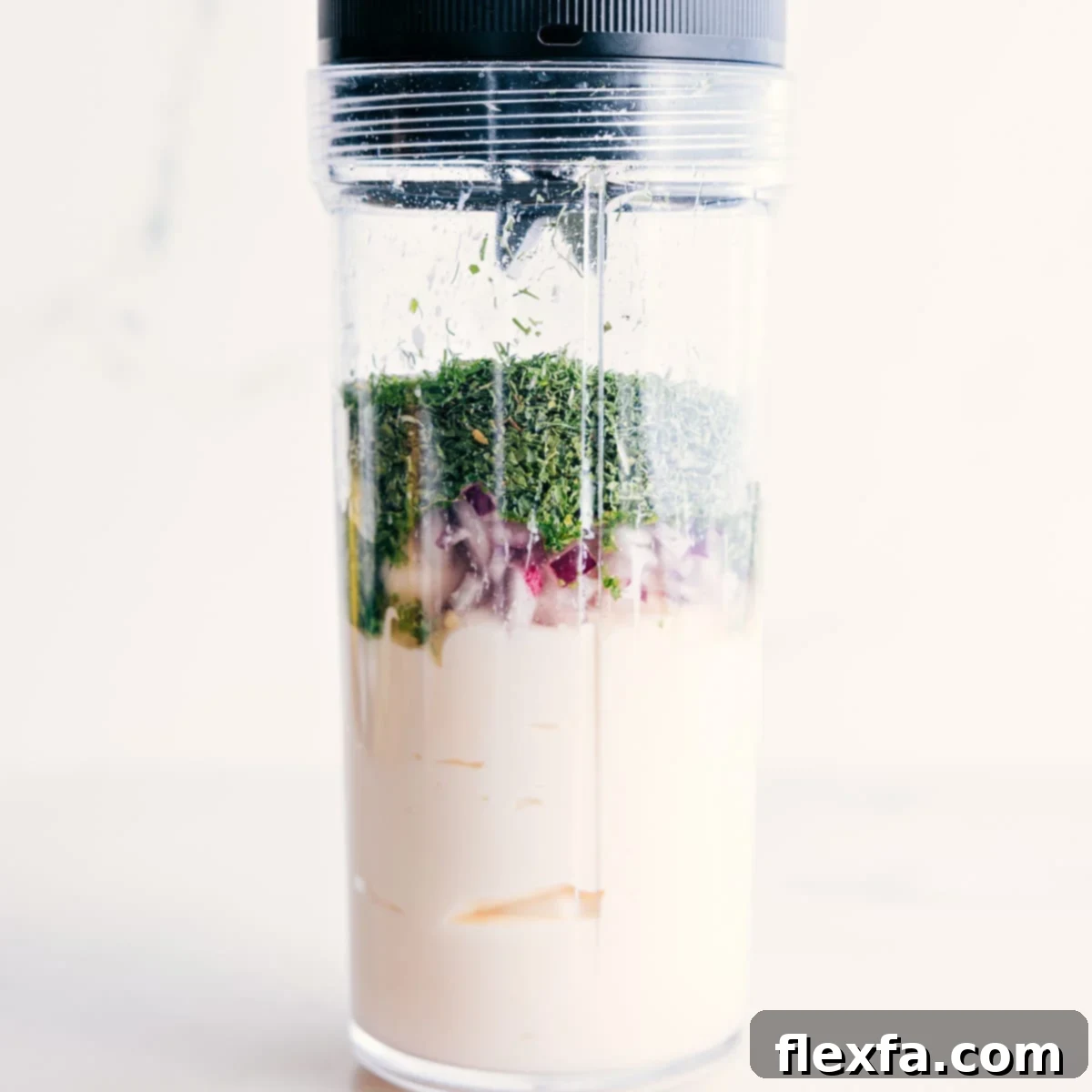 All the ingredients for the green goddess dressing are added to a blender jar, ready to be transformed into a smooth, creamy dressing.