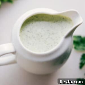 A close-up shot of the perfectly blended Green Goddess Dressing, smooth and ready to be served.