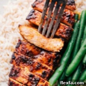 The easy blackened chicken recipe with a fork picking up a piece.