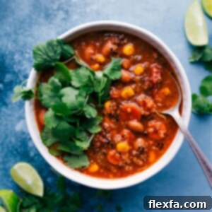 A hearty bowl of Quinoa Vegetable Soup with shredded chicken, ready to serve.