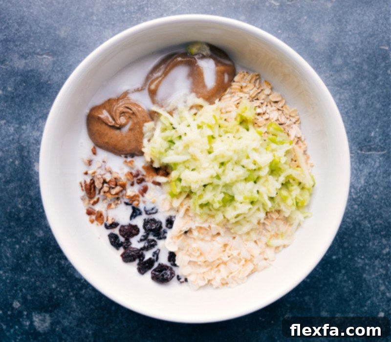 Process shots of Bircher Muesli- image of the apple and milk being added to the bowl