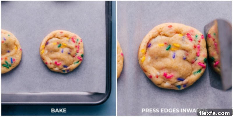 Close-up of a freshly baked Funfetti cookie being pressed inward with a spatula to create perfect edges