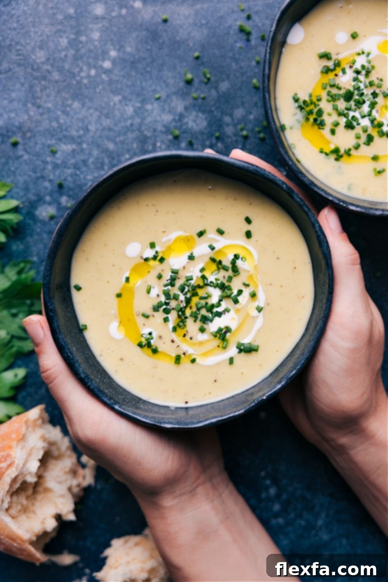 Overhead image of a bowl of creamy Potato Leek Soup garnished with fresh chives.