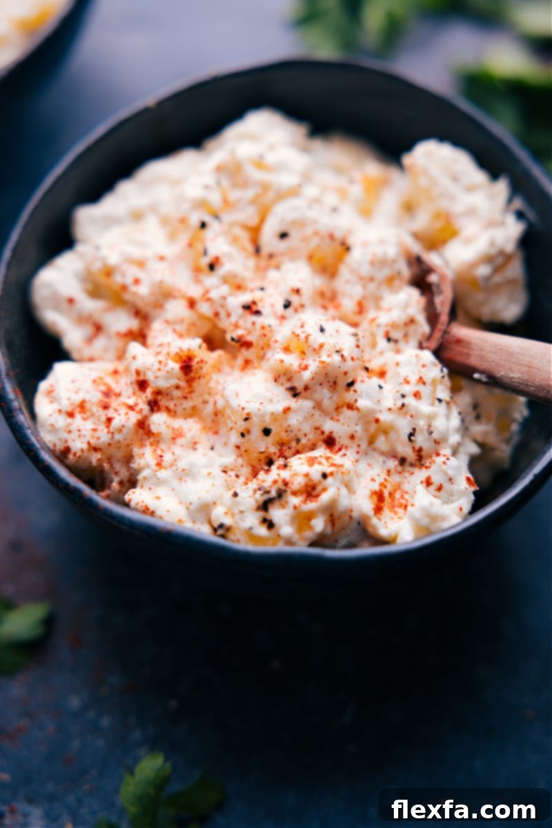 Overhead view of Creamy Potatoes garnished with paprika, showcasing their rich, creamy texture and small, tender potato cubes.