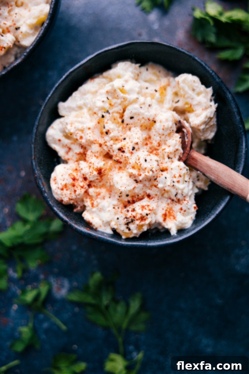 Close-up view of the finished Old-fashioned Creamed Potatoes, beautifully sprinkled with paprika and ready to serve, highlighting their inviting texture and rich color.