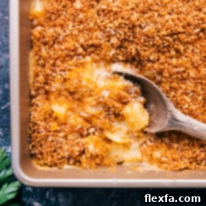 The Best Cheesy Potatoes Recipe with a big scoop ready to serve!