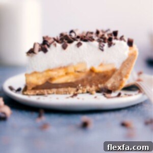 Beautifully plated slice of Banoffee Pie with rich layers and chocolate shavings, ready to be enjoyed.
