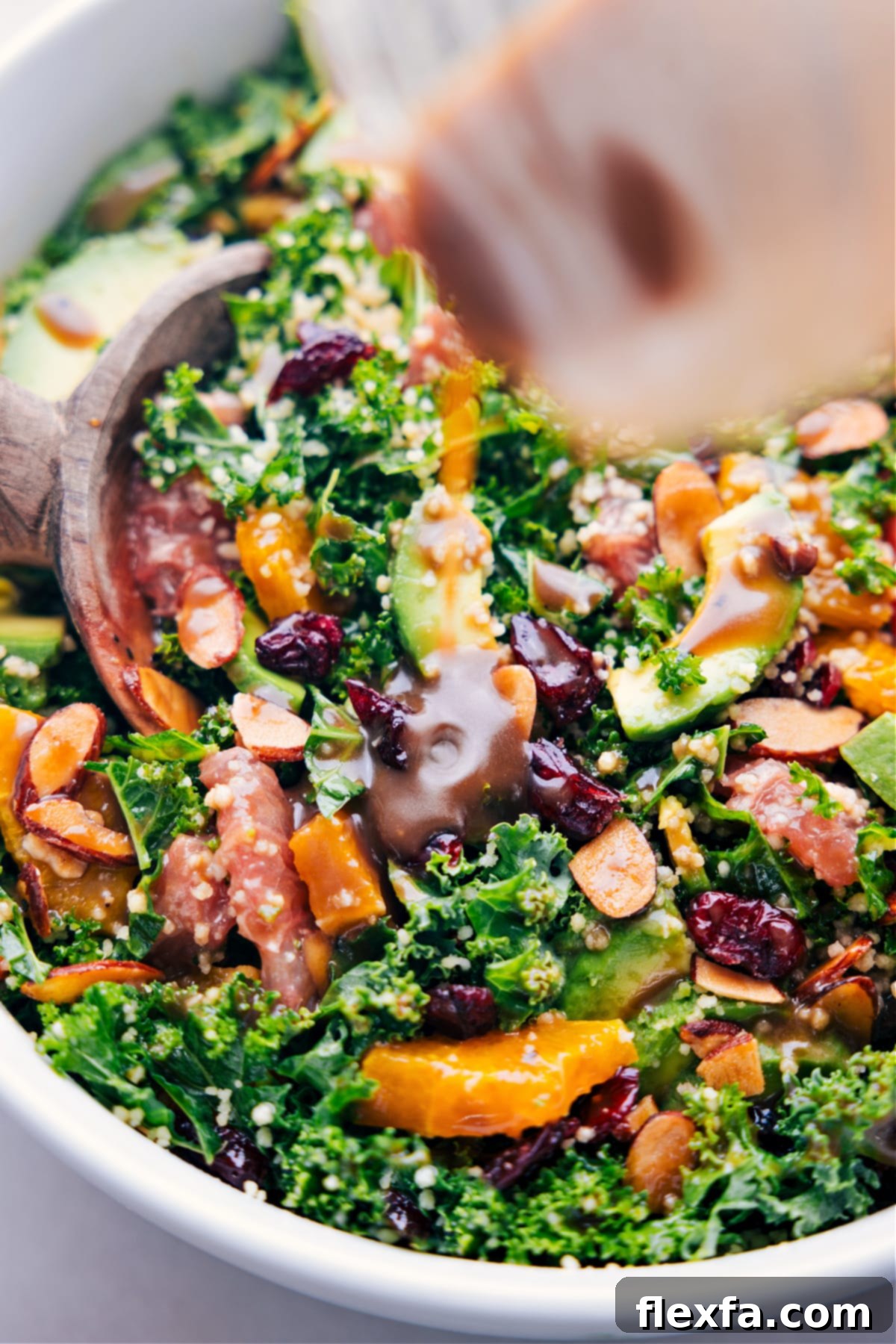 Balsamic dressing being poured generously over the vibrant and easy grapefruit salad, ready for tossing and serving.