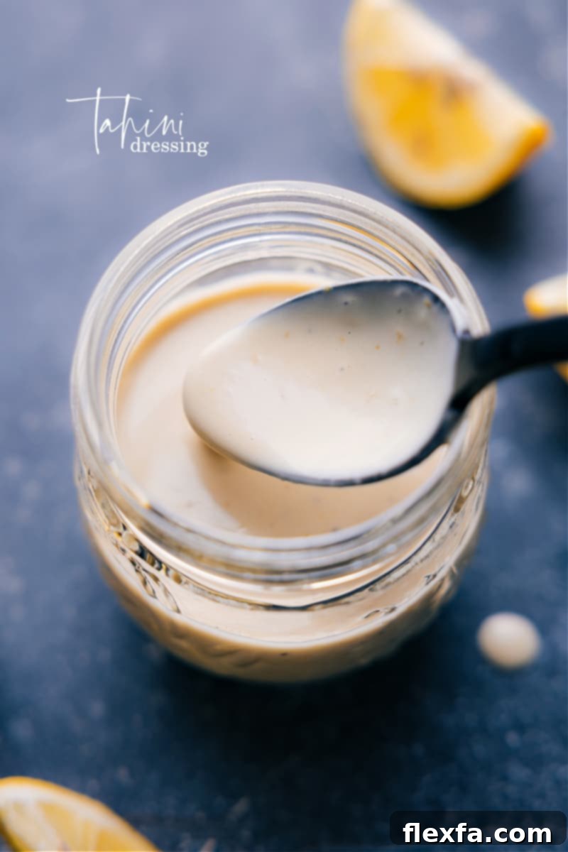 Overhead image of a bowl of creamy lemon tahini dressing ready to be served