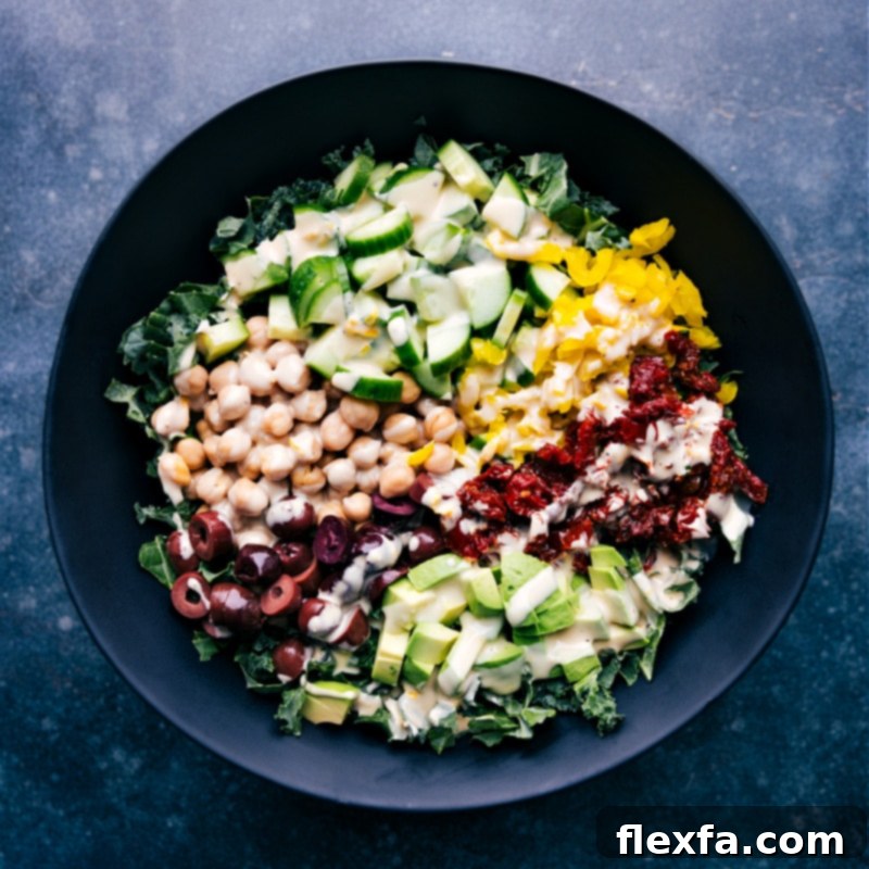 Overhead image of a vibrant green salad tossed with creamy tahini dressing