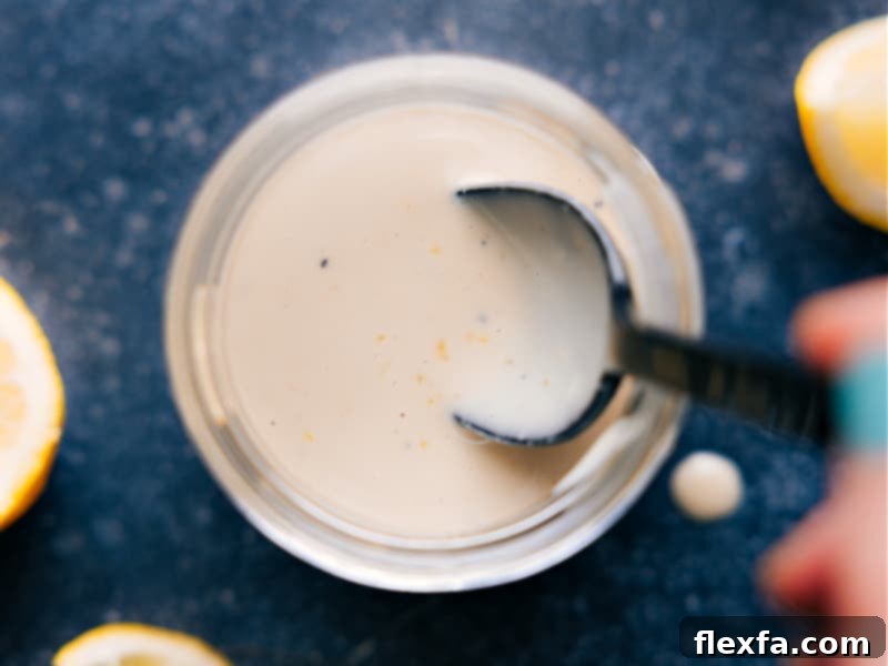 Overhead image of a bowl of finished tahini dressing ready to be enjoyed