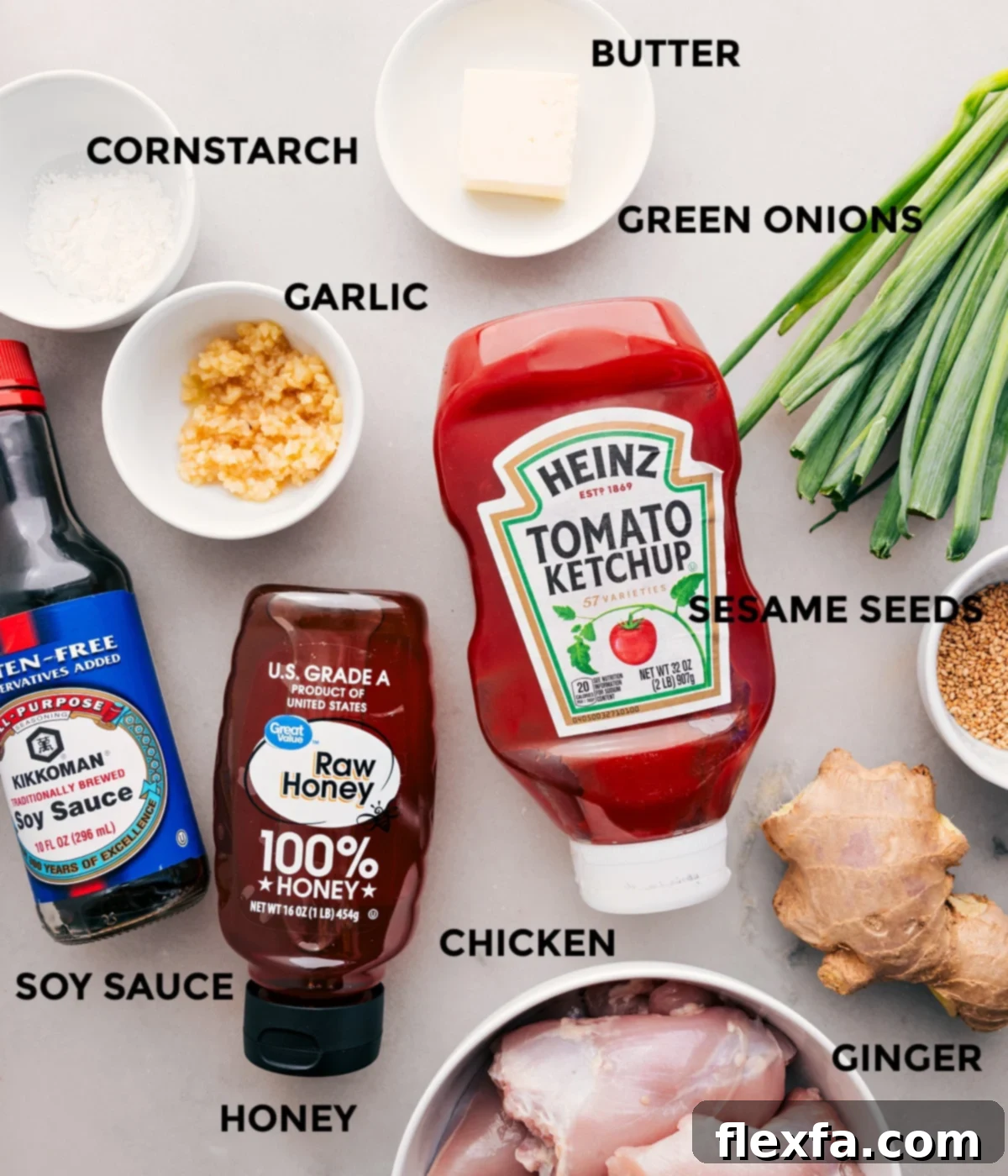 All essential ingredients for Honey Garlic Chicken Thighs laid out: boneless chicken thighs, butter, minced garlic, minced ginger, soy sauce, honey, ketchup, cornstarch, green onions, and sesame seeds.