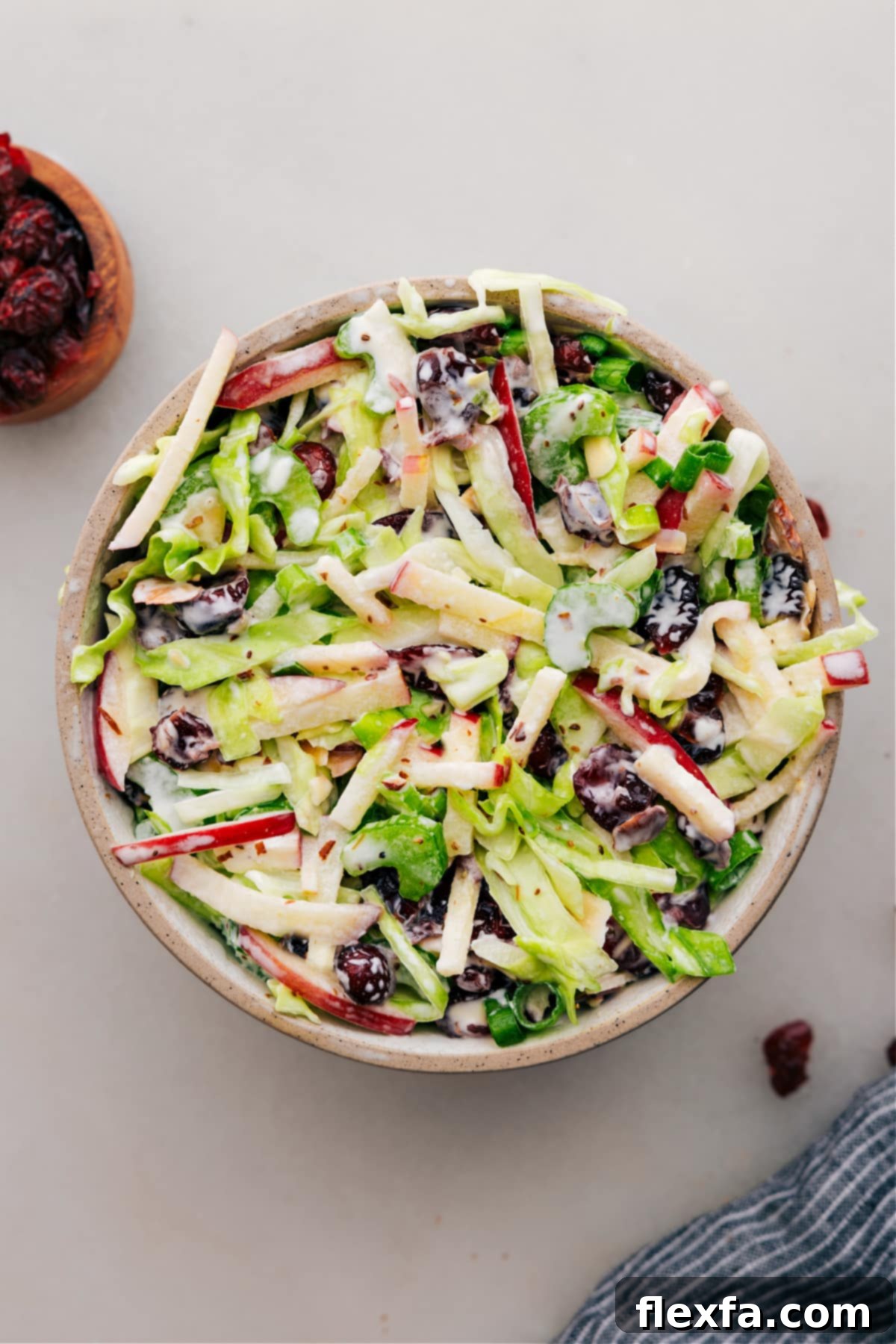 Dressed apple coleslaw in a bowl, ready to serve, showcasing vibrant colors and fresh ingredients.