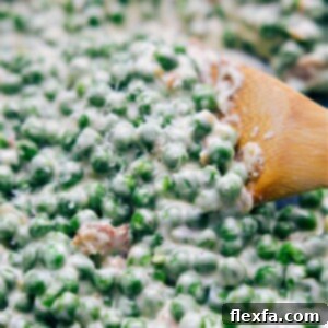 A bowl of Creamed Peas with bacon bits and Parmesan cheese