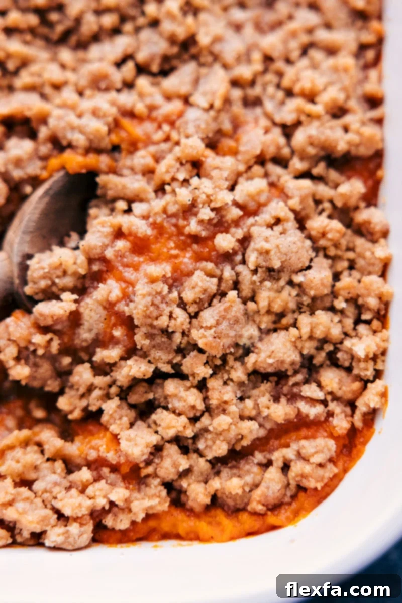 Up close overhead image of the sweet potato casserole being served with a spoon