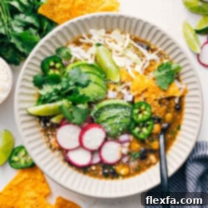 Close-up of Chicken Pozole in a bowl with hominy and broth.
