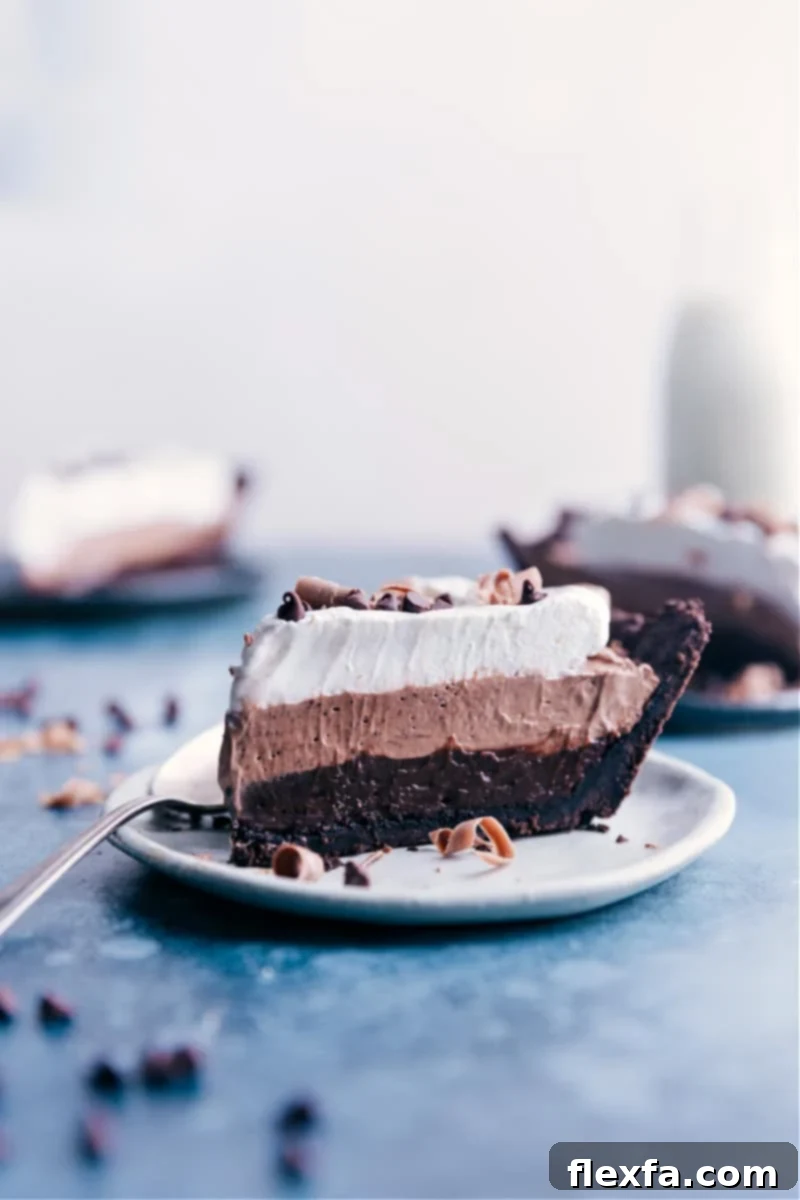 A perfectly portioned slice of the rich, layered Chocolate Pudding Pie, ready to be enjoyed