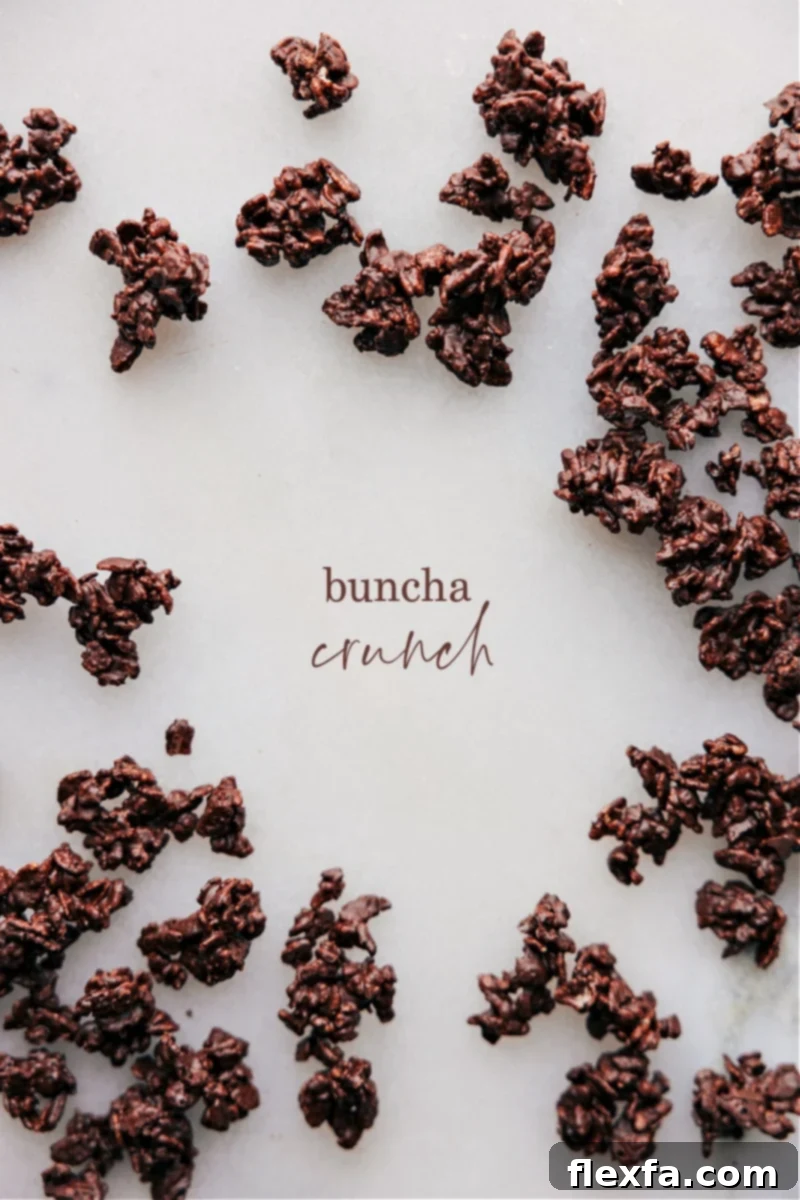 Overhead image of freshly made homemade chocolate Buncha Crunch clusters on parchment paper, ready to be enjoyed.