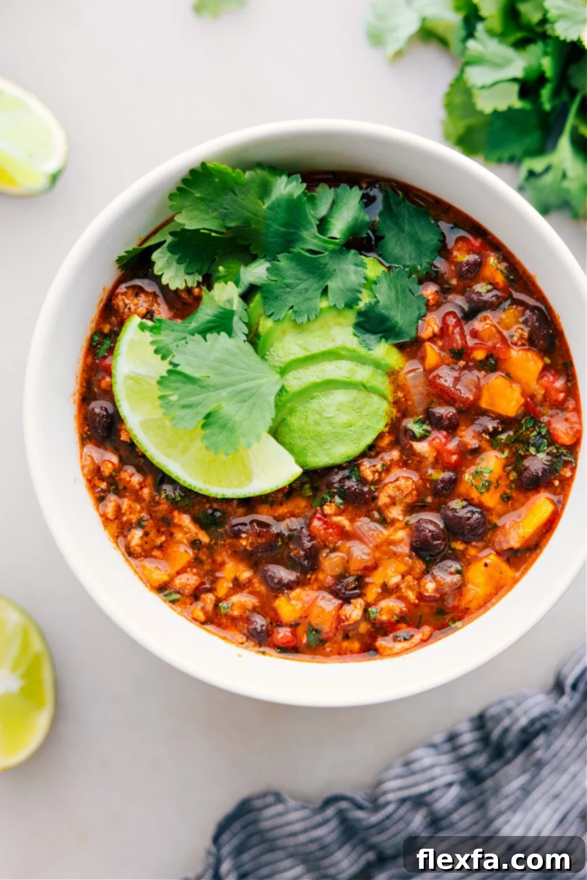 The Best Beef Enchilada Soup Recipe A steaming bowl of Beef Enchilada Soup, garnished with fresh cilantro and a dollop of sour cream, ready to be enjoyed on a cozy evening.