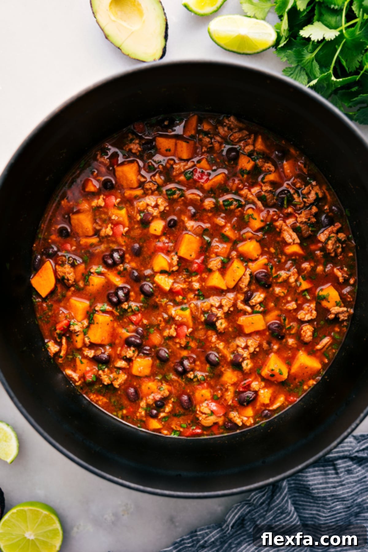 One Pot Beef Enchilada Soup Recipe Ready to Serve A large pot filled with the bubbling, rich Beef Enchilada Soup, generously garnished with fresh cilantro, showcasing its hearty and inviting texture ready to be served.