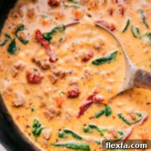 A bowl of freshly made Tuscan Soup, garnished with crispy bacon, grated Parmesan cheese, and fresh parsley.