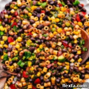 Close-up of a serving of Cowboy Caviar Pasta Salad, showcasing its vibrant ingredients and delicious dressing.
