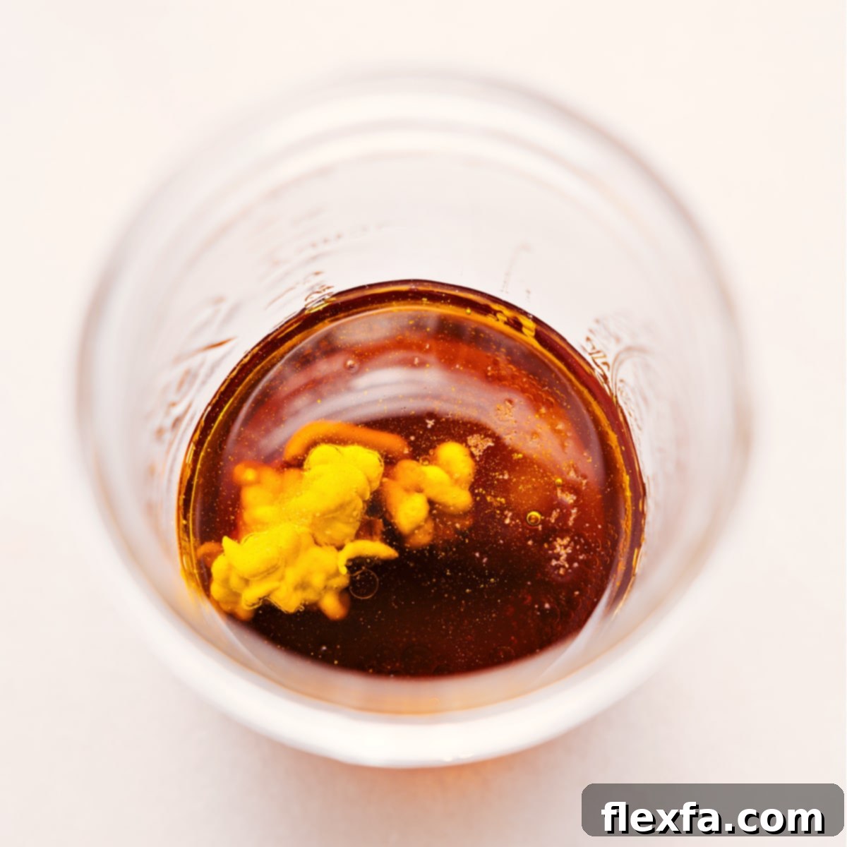 All the pre-measured ingredients for White Balsamic Vinaigrette are combined in a classic mason jar, ready to be vigorously shaken and mixed into a perfect dressing.