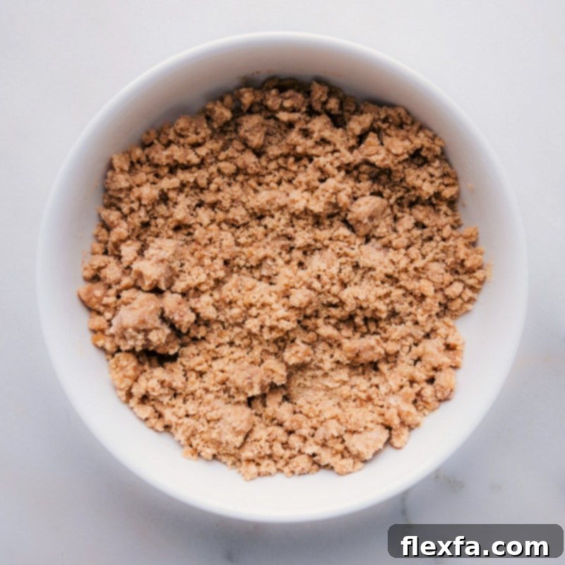 Overhead image of freshly made streusel in a ceramic bowl, showcasing its perfectly crumbly texture, ready for baking.