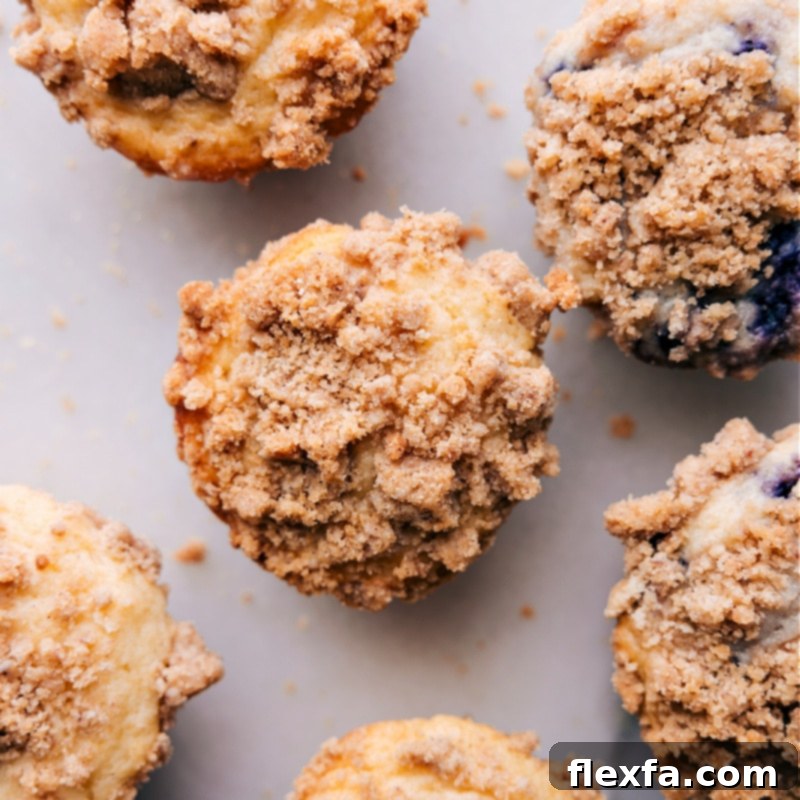 Overhead image of freshly baked muffins topped with generous amounts of golden-brown streusel, ready to be served.