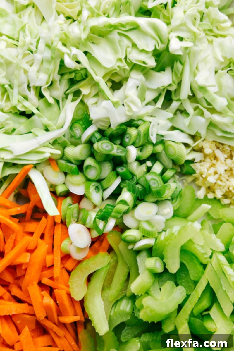 Freshly chopped vegetables ready to be added to the chicken chow mein, including cilantro, carrots, green onions, and cabbage.