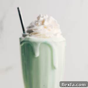 Homemade Shamrock Shake in a tall glass with whipped cream.