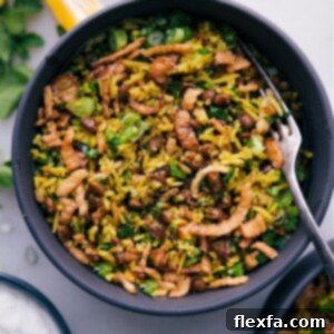 A delicious bowl of Mujadara (Mejadra) garnished with fresh herbs and caramelized onions.