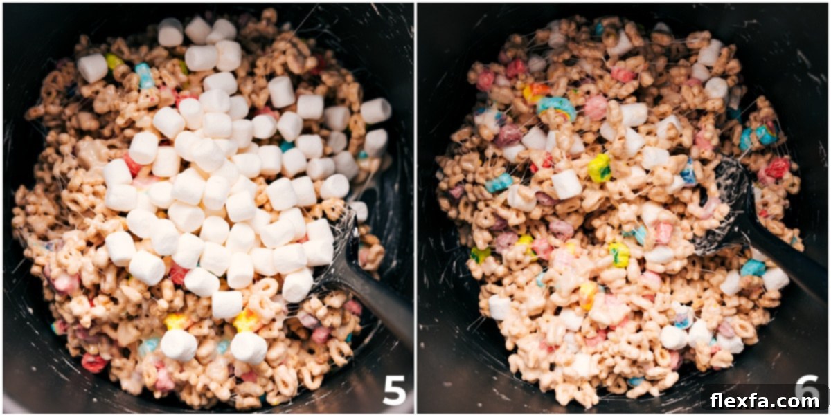 The vibrant Lucky Charms cereal and marshmallows fully coated in the gooey marshmallow mixture, ready to be pressed into a pan.